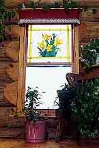Daffodils in stained glass by the author's wife, Andrea, in their log home.