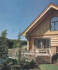 large deck wrapping water side of log house