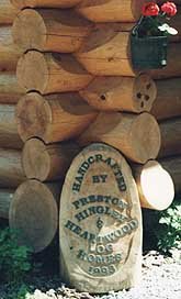 artistically engraved plaque by skillful carpenter proud to association with Heartwood Log Homes